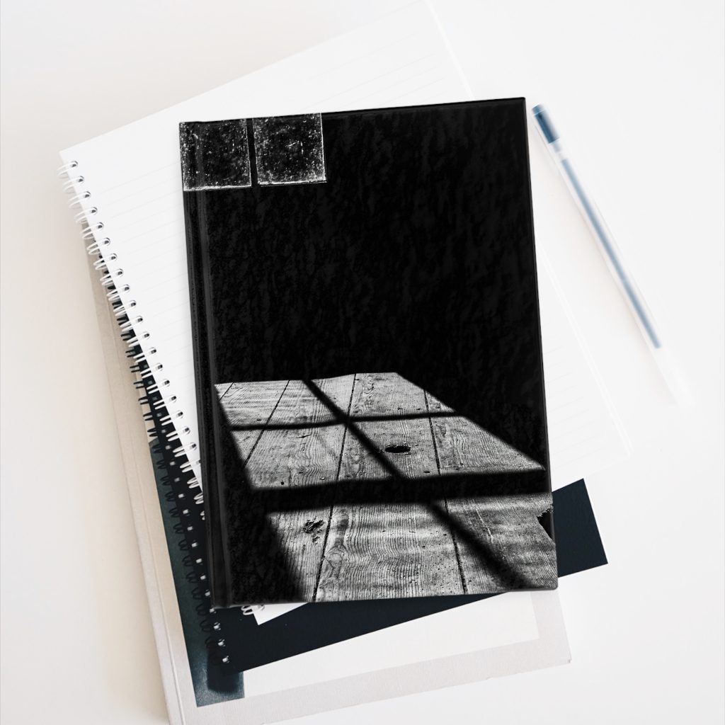 Cabin Window hardcover journal on stack of books